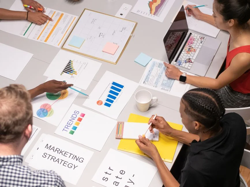 services-02 Flat lay showing branding materials and design concepts for creative strategy discussions.